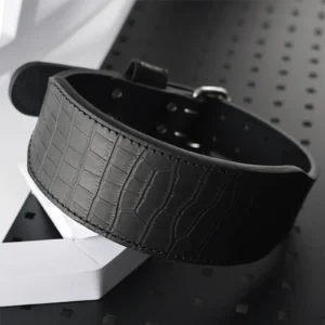 A premium, multi-layer leather belt designed for serious powerlifting. It provides essential core stability and lumbar support during heavy lifts through its 10mm contoured construction and secure buckle. Built for durability with high-quality materials, it features a professional, understated look and offers optional personalization.